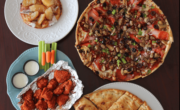table of pizza and wings