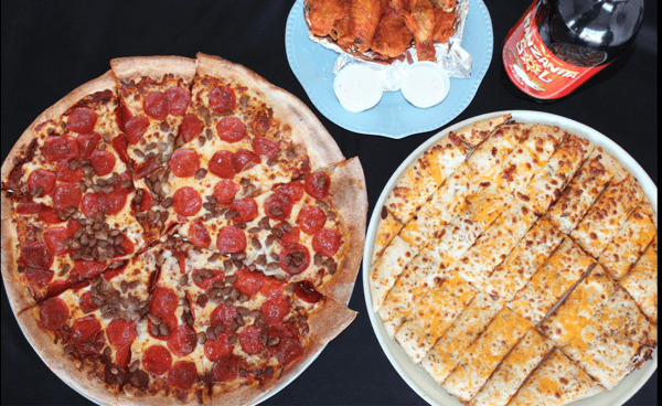 table of pizza and wings