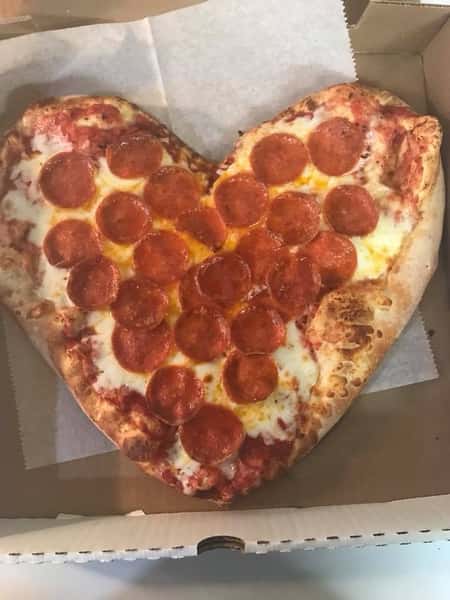 A heart shaped pizza with pepperoni