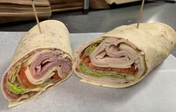 Open faced wrap with meats, cheese, lettuce, tomato