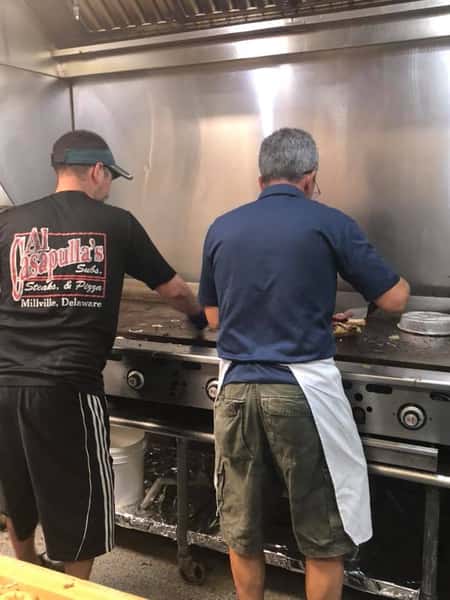 Chefs cooking on a grill