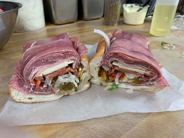 Open faced sandwich with meats, cheese, lettuce, tomato