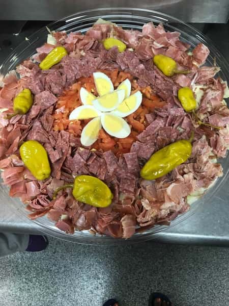 Meat platter with assorted meats and topped with eggs