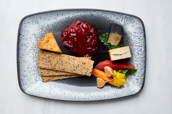 Cheese Plate. Three types of cheese. Seeded crackers. Marmalade