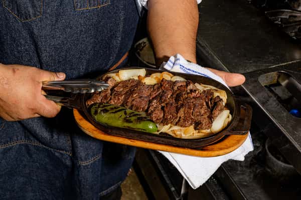 Fajitas being served at Flora Mexican Kitchen