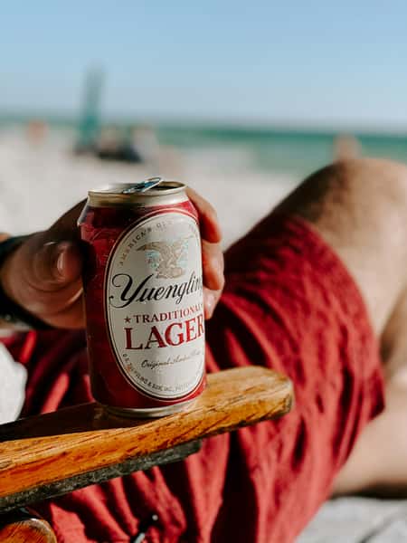 Beer on a seat on the beach