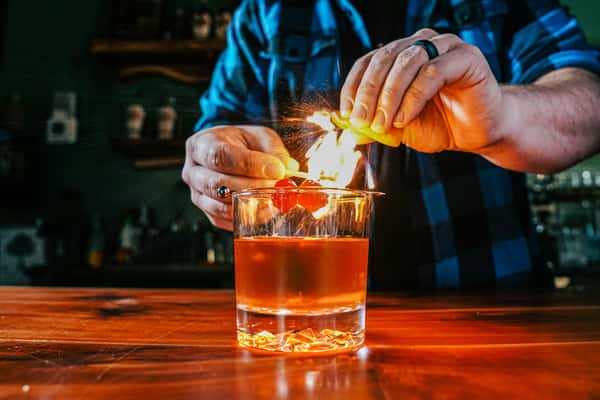 Bartender with a flaming cocktail