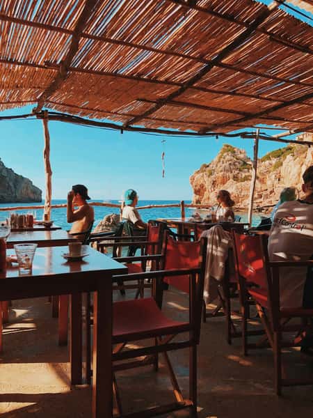 Beach bar with people under in the shade