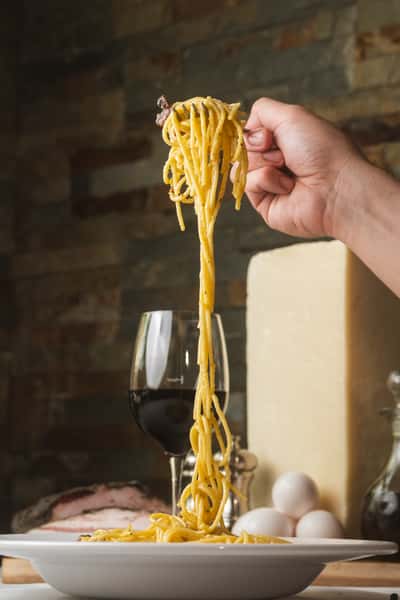 Pasta Photo with Glass of Red Wine in the Background