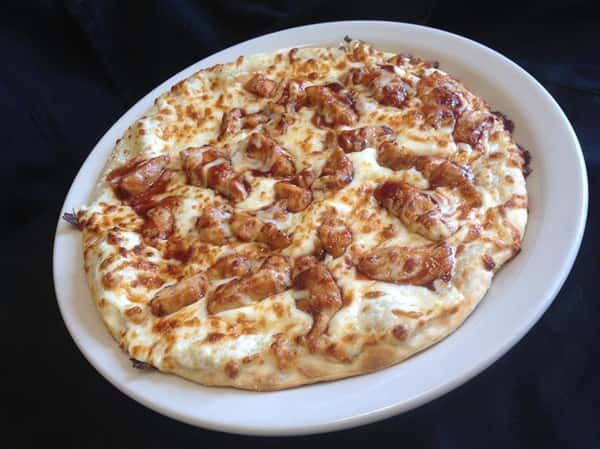 Pizza topped with chicken and melted cheese