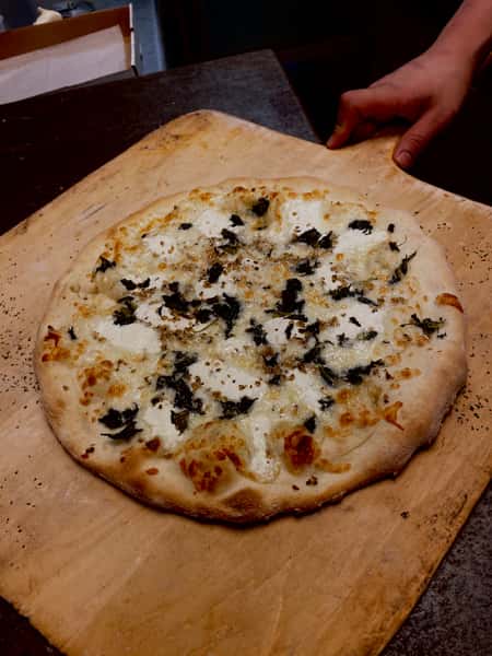 White pizza on wooden board