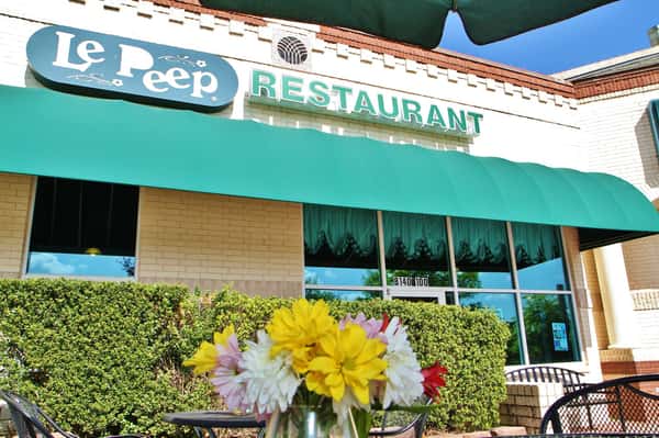 Exterior of Le Peep Restaurant with a small bouquet of flowers in the foreground