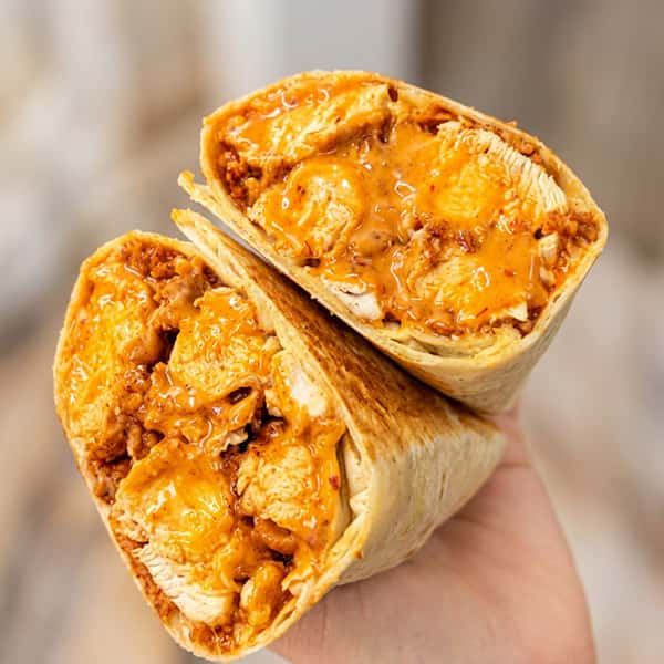 Grilled chicken wrap filled with tender chicken pieces and creamy spicy sauce