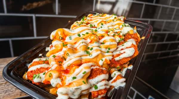 @Lunch loaded fries topped with crispy chicken, creamy herb sauce, spicy sauce, and chopped chives