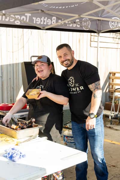 Crew members serving food outdoors