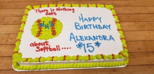 Rectangle cake decorated with a softball that says "there is nothing soft about softball" and Happy Birthday Alexandra *15*"