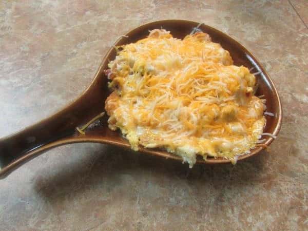 Skillet of food topped with melted shredded cheese