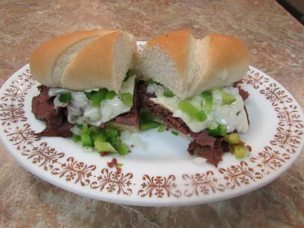 Thinly sliced Prime rib, green peppers, onions, swiss cheese on toasted French roll