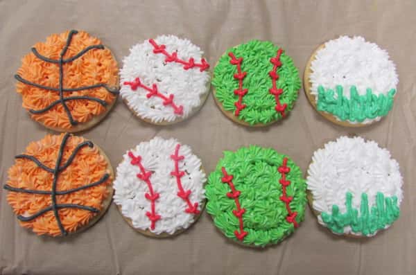 Cookies frosted to look like basketballs, baseballs, and tennis balls
