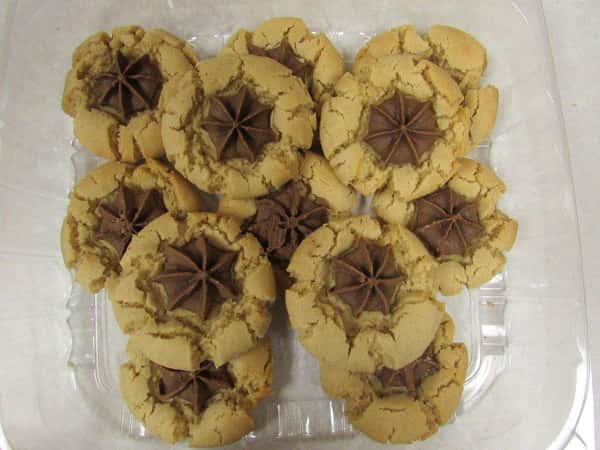 A container filled with cookies with chocolate in the center