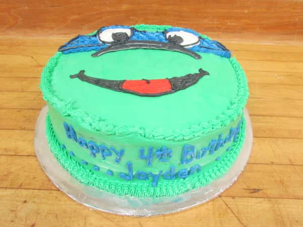 Teenage Mutant Ninja turtle cake with "happy 4th birthday Jayden" frosted on the side