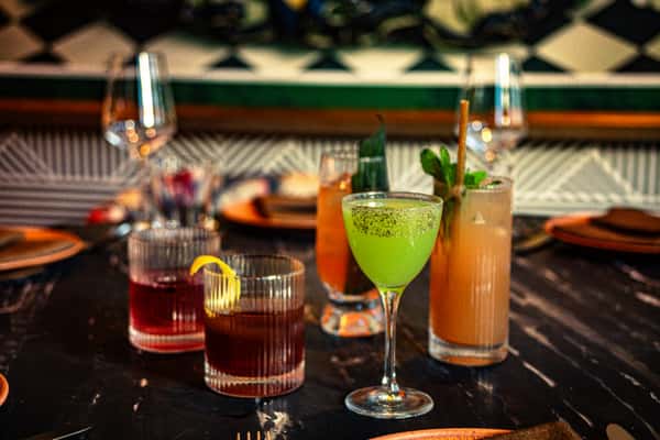 Colorful handcrafted cocktails displayed on a marble dining table in a stylish contemporary restaurant bar