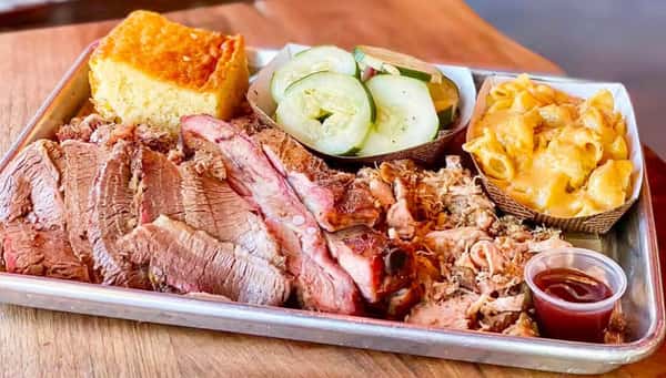 tray of sliced brisket with sides