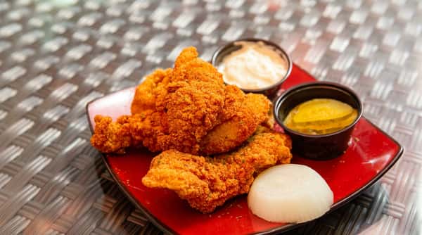 Crispy fried chicken tenders with dipping sauces at DSquared in St. Louis