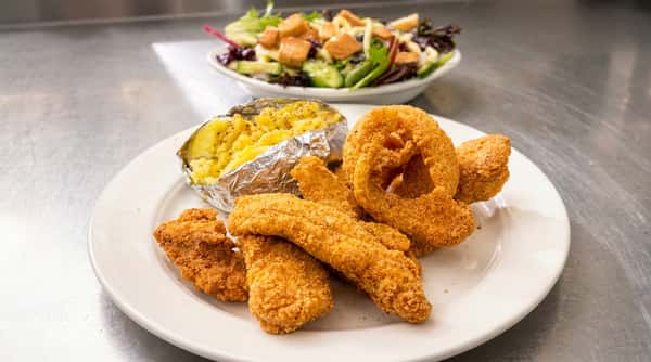 Crispy fried fish with loaded baked potato and onion rings at DSquared in St. Louis