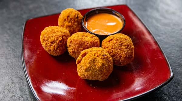 Crispy fried croquettes with creamy dipping sauce at DSquared in St. Louis