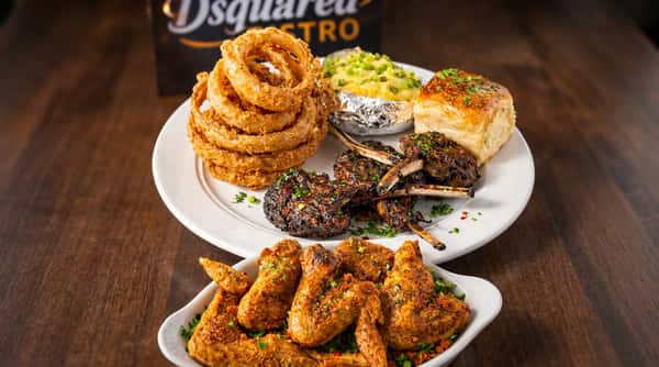 Seasoned lamb chops platter with onion rings and sides at DSquared in St. Louis