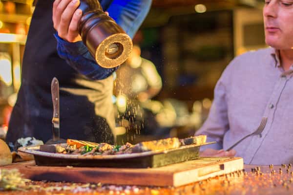 waiter grinding pepper
