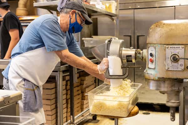 person grating cheese