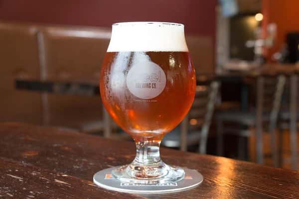 a glass of beer on the bar
