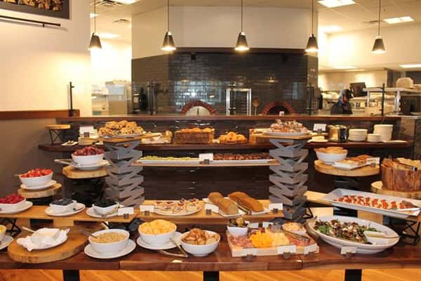 a view of a varitey of food items out on long tables