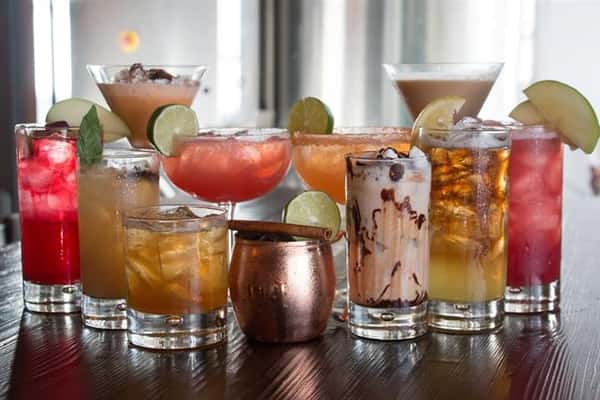 a variety of alcoholic drinks on the bar