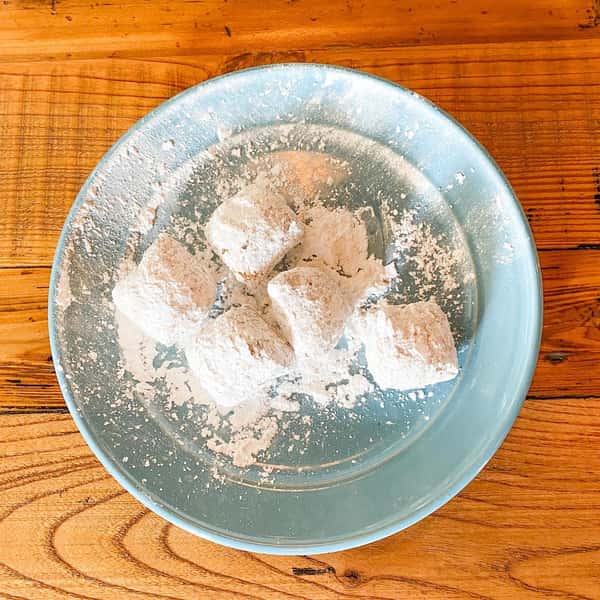 beignets on a plate on wooden table