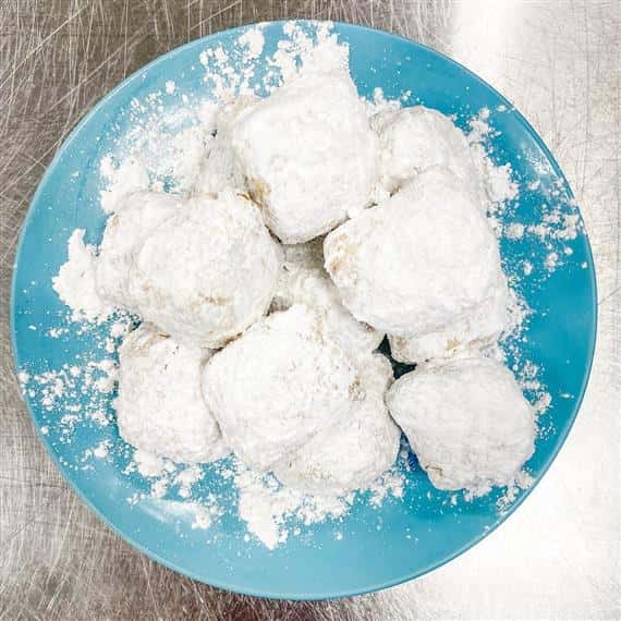 powdered beignets on a plate on counter