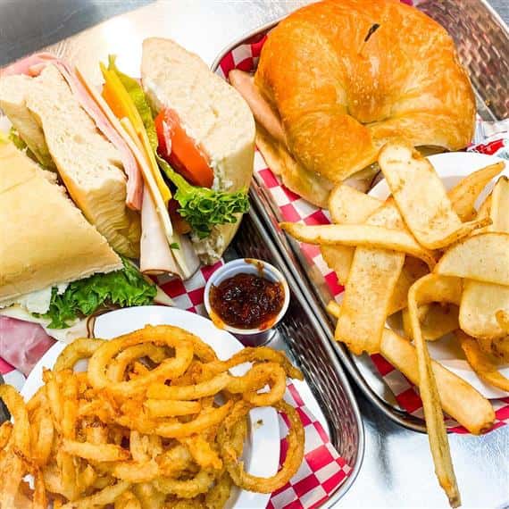 sandwichs with onion rings plus ham bagel with fries