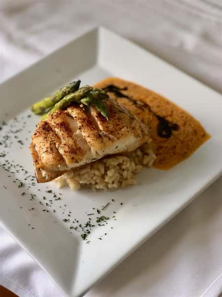 PARMESAN COD: tomato chive buerre blanc, risotto, and vegetables