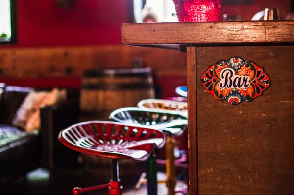 bar stools and bar sign