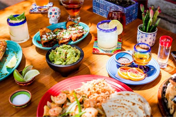 assorted mexican dishes and margaritas