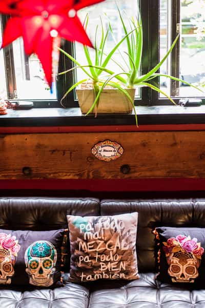 bar seating with mexican designed pillows