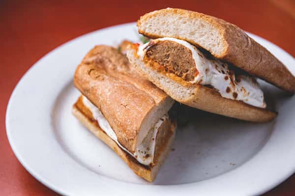 Toasted Italian sandwich filled with breaded chicken, melted cheese, and tomato sauce on crusty bread.