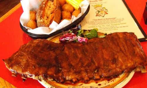 bbq ribs with a basket of tator tots and baked potato