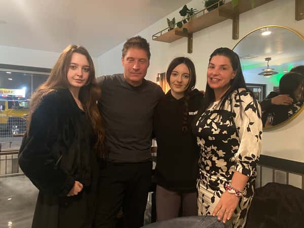 People posing inside restaurant