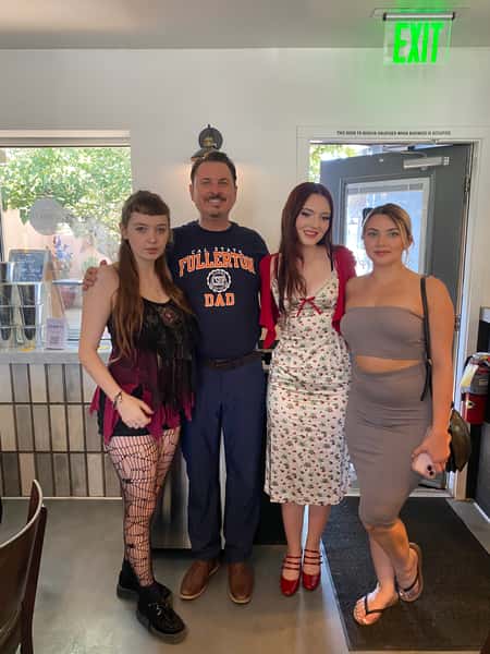 People posing inside restaurant