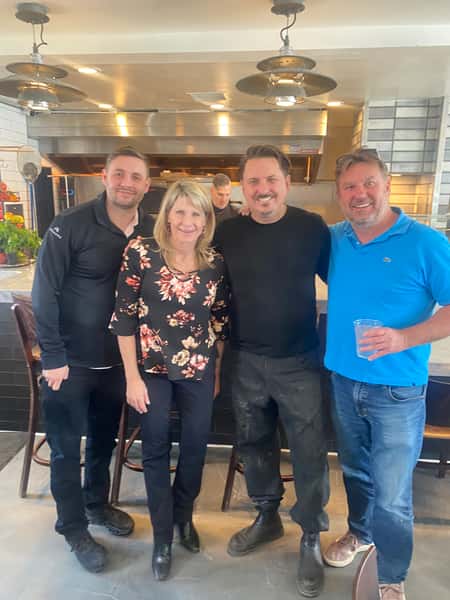 People posing inside restaurant