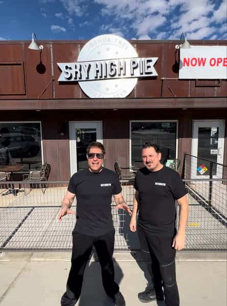 Men standing in front of restaurant