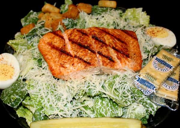 cesar salad topped with salmon